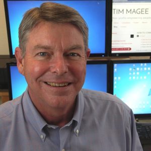 Photo of Tim Magee sitting in front of his computer