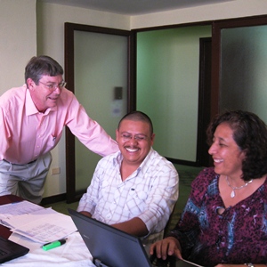 Man leading a workshop speaking to 2 participants.