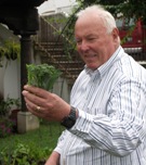 Ricardo Frohmader with freshly picked broccoli in his garden.