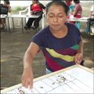 Woman voting during the workshop to prioritize community need.